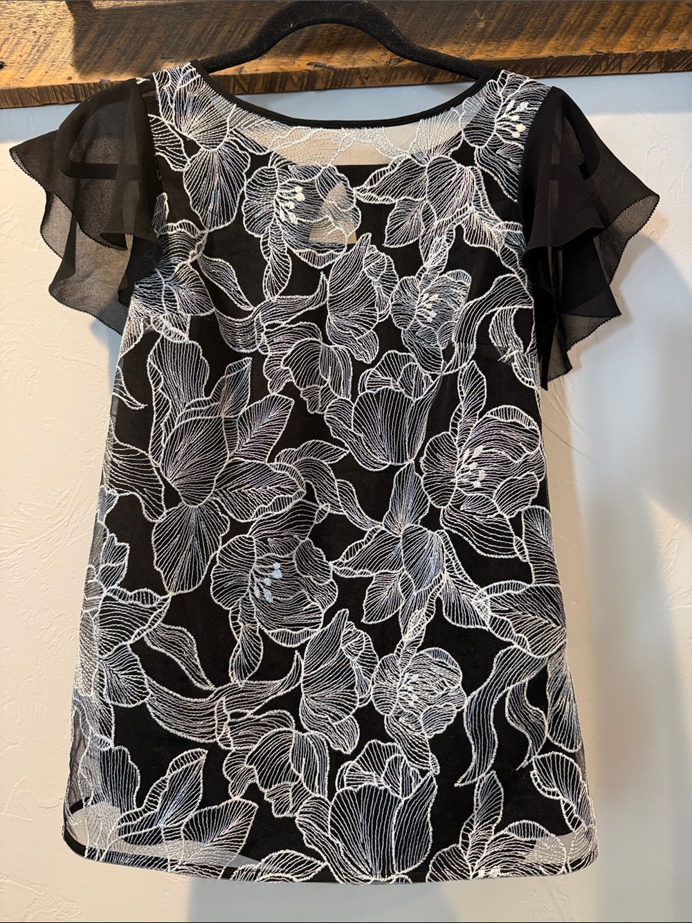 Beautiful White House Black Market Black Top with White Floral Lace Overlay